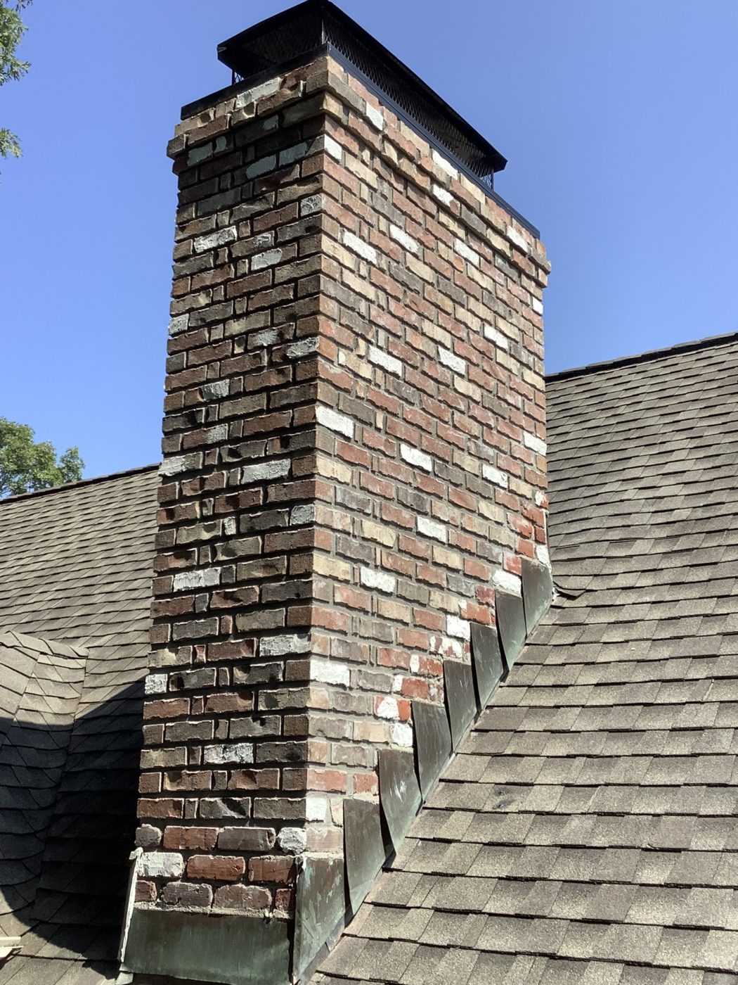 Rebuilt brick chimney on a Knoxville-area roof by B & C Masonry